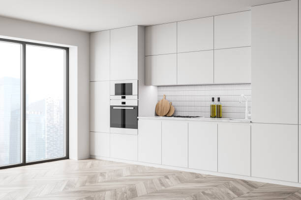 istock White kitchen interior with cupboards and built in appliances 1330536575