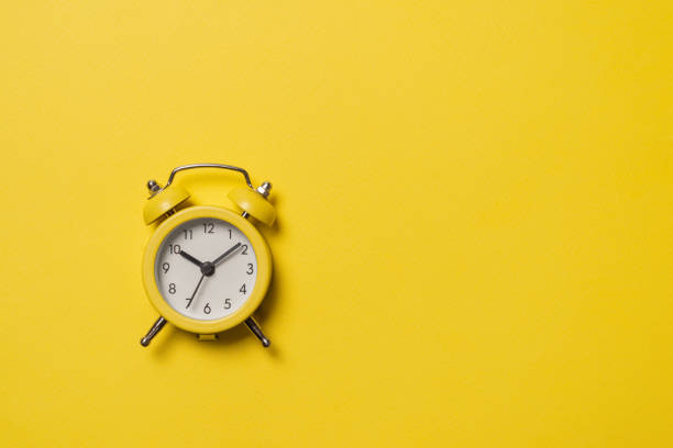 istock Yellow alarm clock on a yellow background. Copy space. Time concept. 1330539823