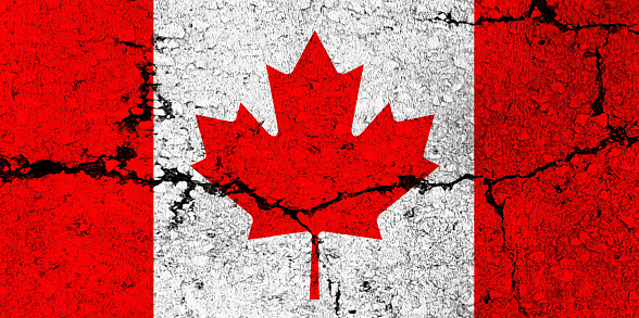 Canadian Flag on cracked wall background.