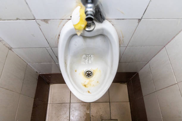 istock Dirty and smelly urinal bowl with limescale stain deposits 1330540029