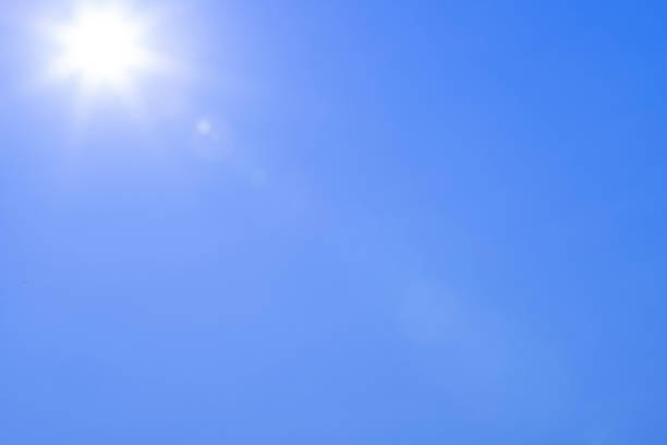 istock sun with beams in the blue sky as background 1330541773