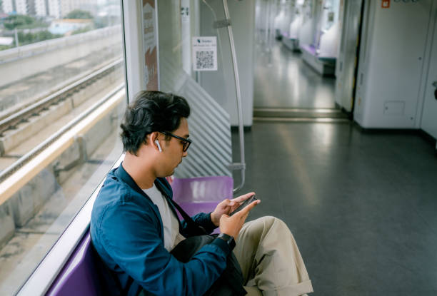 istock Man traveling by subway train  wearing protective mask during coronavirus outbreak  using phone. 1330544364