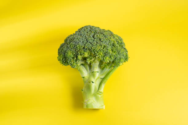 istock Brocolli on the yellow background 1330545682