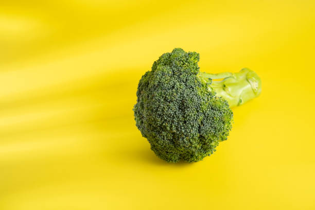 istock Brocolli on the yellow background 1330545820