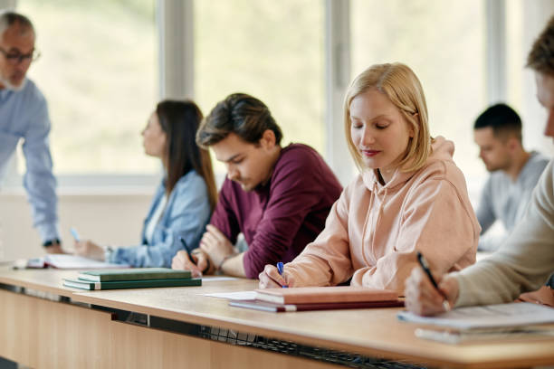 istock Female university student writing an exam in the classroom. 1330545862