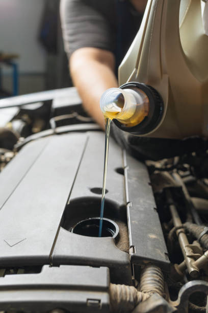 istock An auto mechanic pours engine oil, close-up 1330548106