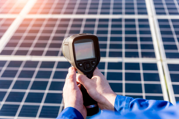 istock Inspector examination of photovoltaic modules using a thermal imaging camera 1330548152