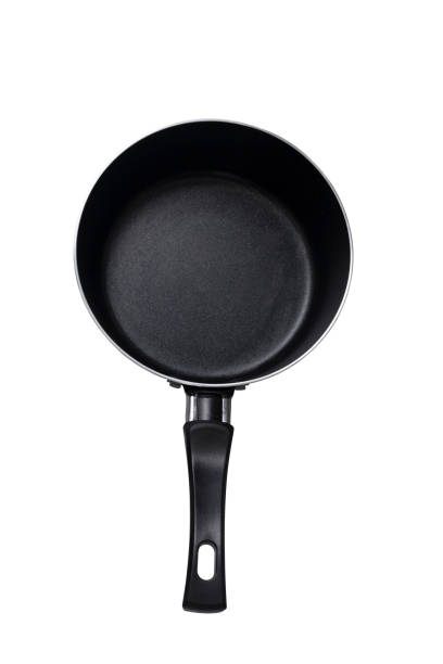 istock Black frying pan isolated on white background with clipping path - Empty pan on a dark background, top view 1330548611