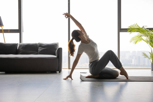 istock Young women practicing yoga indoors 1330550454