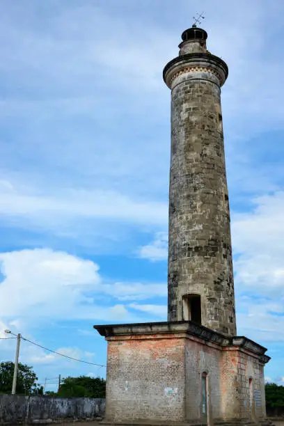 Grand-Bassam, Aboisso department, Sud-Comoé region, Comoé district, Ivory Coast / Côte d'Ivoire: colonial lighthouse completed in 1914,  round masonry tower, typical of the military architecture of the time - deactivated in 1951 with the opening of the port of Abidjan and the new lighthouse of Port-Bouët - UNESCO world heritage site - known simply as 'le phare'.