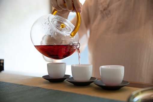 Tea pouring into cup