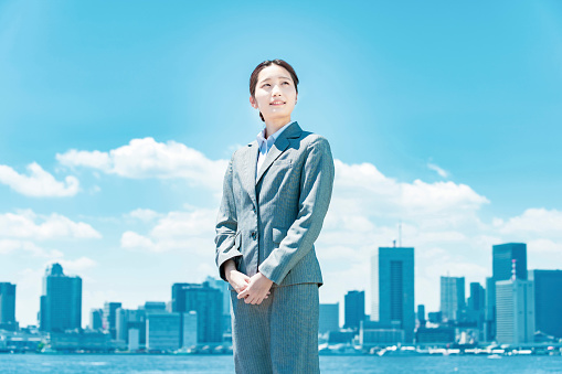 City center, blue sky and asian young business woman