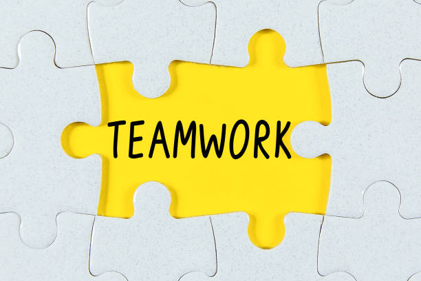 istock Missing a pieces of puzzle in the center, yellow space with word Teamwork 1330552931