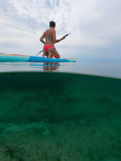 istock Woman kneeling and paddling 1330553150