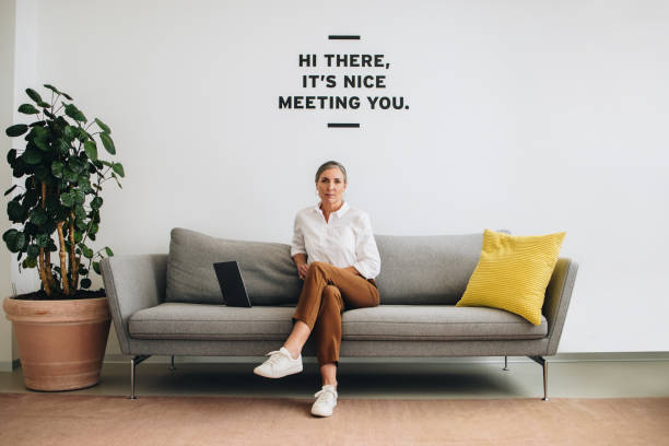 istock Female business professional sitting on sofa 1330553364