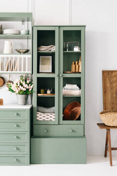istock Tall green vingate cupboard with glass doors 1330554408