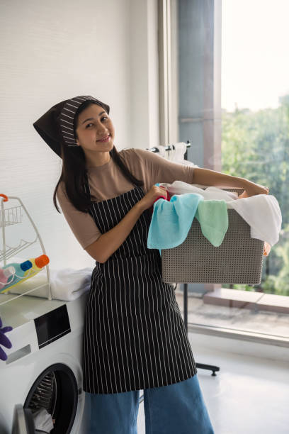 istock Smiling woman carry laundry basket for launder 1330558093