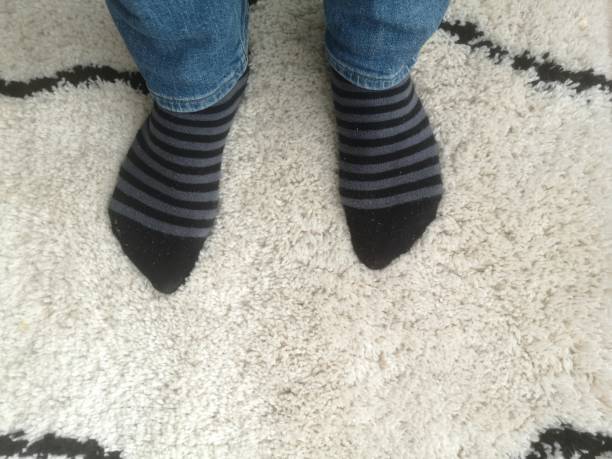 istock man with socks on carpet, top view 1330560102
