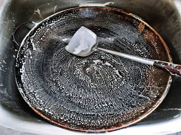 istock Cleaning dirty cooking pan and ladle. 1330561326