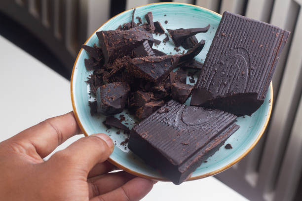 istock Milk dark chocolate pieces isolated on blue plate from. 1330563127