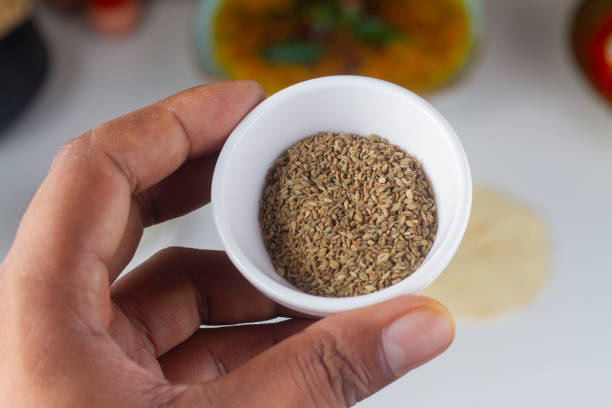 a person holding a celery seed bowl in hand isolated on light background.