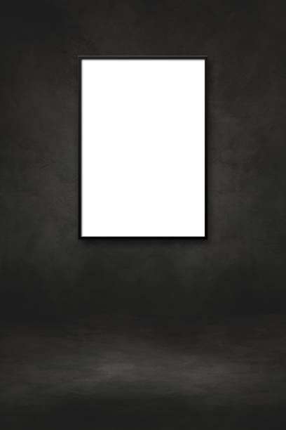 istock Blank picture frame hanging on a black wall 1330564946