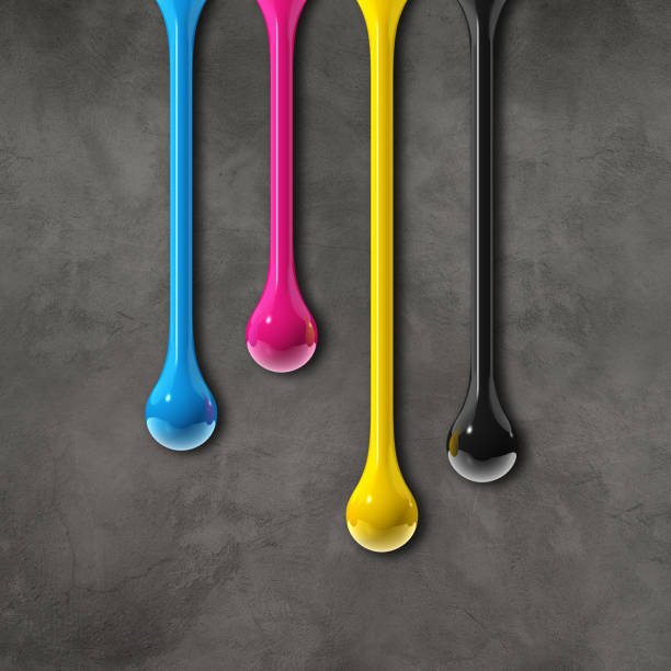 istock cmyk ink drops on dark concrete square background 1330564995
