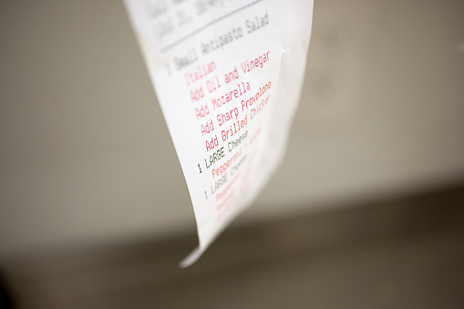 A closeup view of a pizzeria restaurant order receipt.