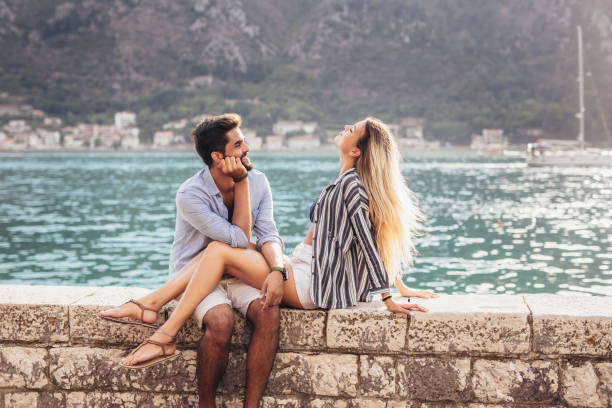 istock Happy young couple laughing and hugging on the beach 1330566213