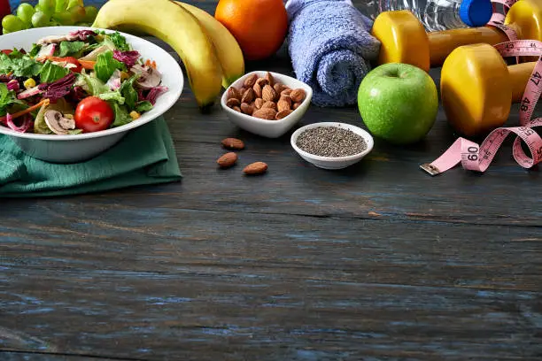 Healthy eating and diet concepts with copy space. Spring salad shot from above on rustic wood table