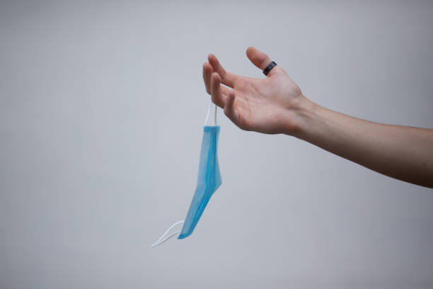 istock Hand holding a medical mask 1330566988