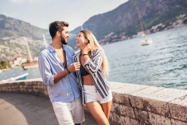 istock Happy young couple laughing and hugging on the beach 1330567045