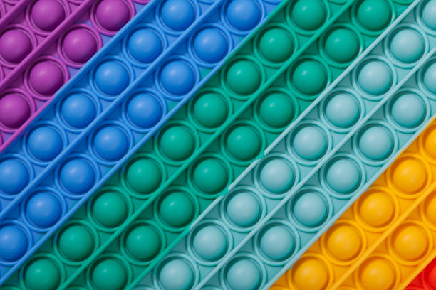 Trendy silicone toys (Snapperz, Pop it, Simple Dimple) on white background Selective focus, copy space
