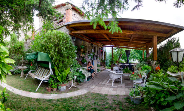 Fennel, Umbria, Italy: Donna reads the book under the veranda of the old farmhouse