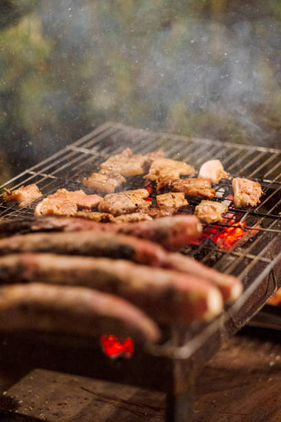 istock Family making barbecue in dinner party camping at night 1330578549