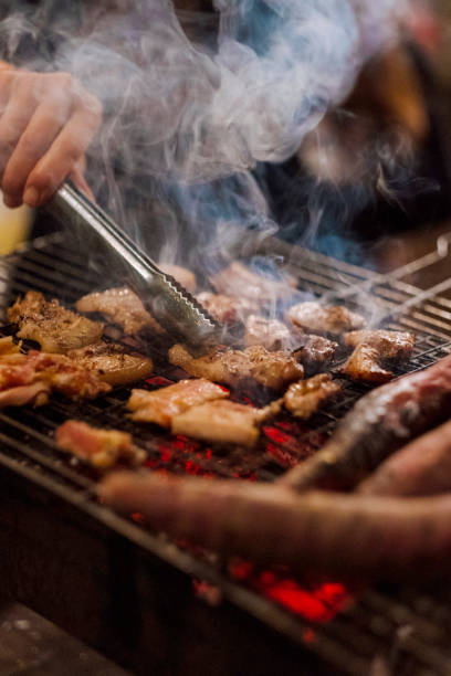 istock Family making barbecue in dinner party camping at night 1330578571