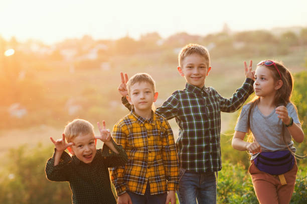 istock Three brothers and sister sunset 1330579769