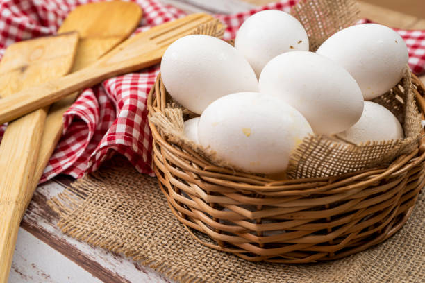 istock Organic white chicken eggs in a wicker basket with burlap cloth . 1330579807