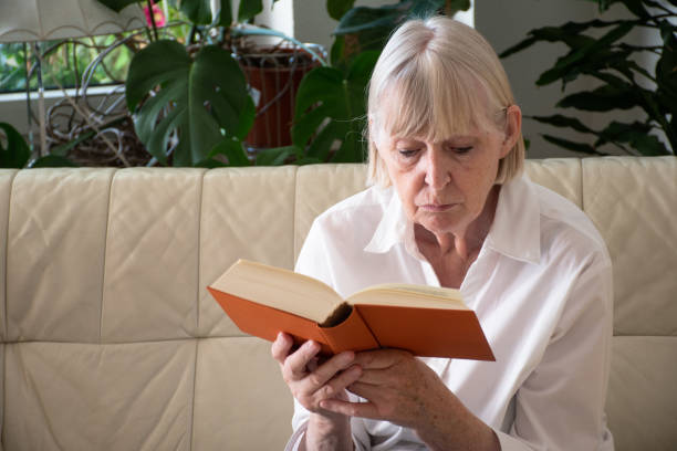istock Senior Woman Reading Book 1330579847