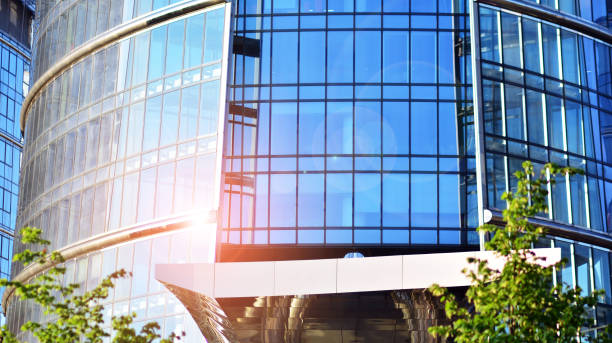 istock Eco architecture. Green tree and glass office building. 1330579857