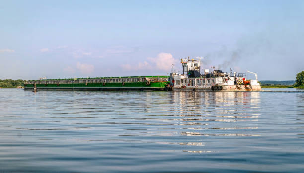istock River barge and tugboat carrying cargo on the river 1330579885