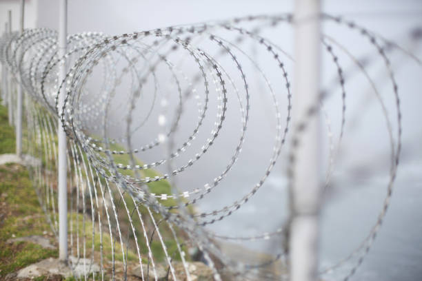 istock Prison security fences, barriers, wire netting. 1330581376