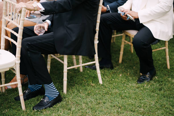 istock Men in suits sit on chairs on the lawn 1330587089