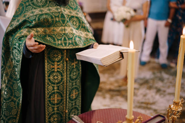istock Priest at the wedding holds a Bible in his hand 1330587262