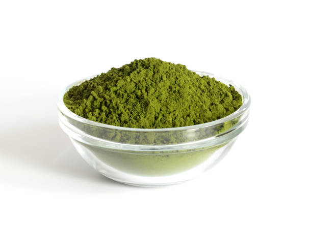 istock Chlorella powder in a bowl isolated on a white background. Green spirulina algae powder or barley. Detox superfood. 1330587745