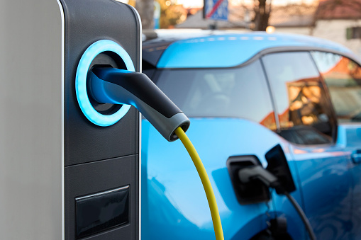 Full frame daylight image with focus of a plug-in electric vehicle charging station in Germany