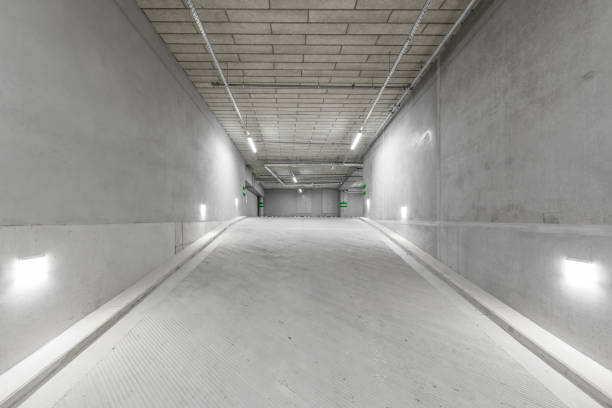 istock Empty public underground parking lot or garage interior with concrete stripe painted columns and signs 1330590740