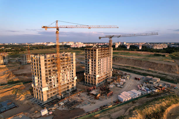 istock Tower crane on construction site on sunset background. Arial view of the cranes the conctruct the high-rise building. 1330593095