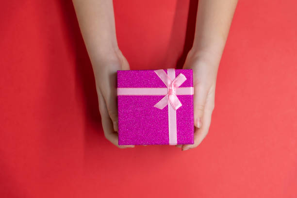 istock Woman holds gift 1330593217
