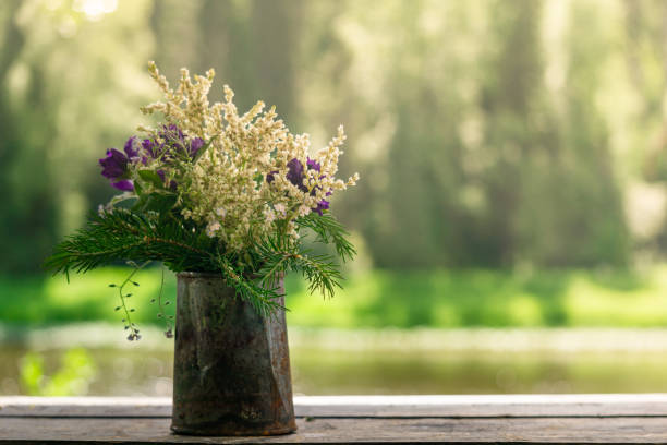 bouquet of wild field plants in a rusty tin can on a blurred natural background